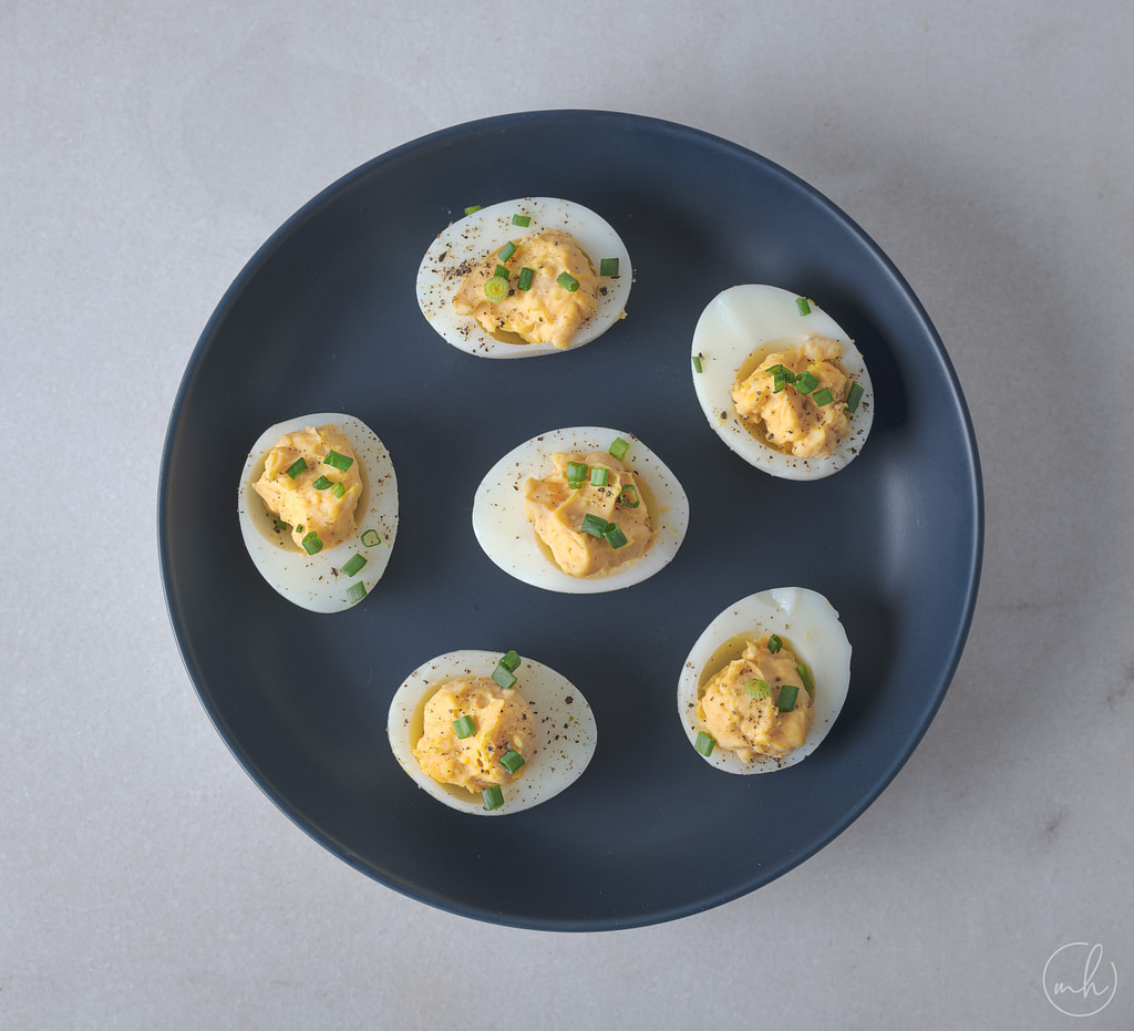 classic deviled eggs placed on blue plate