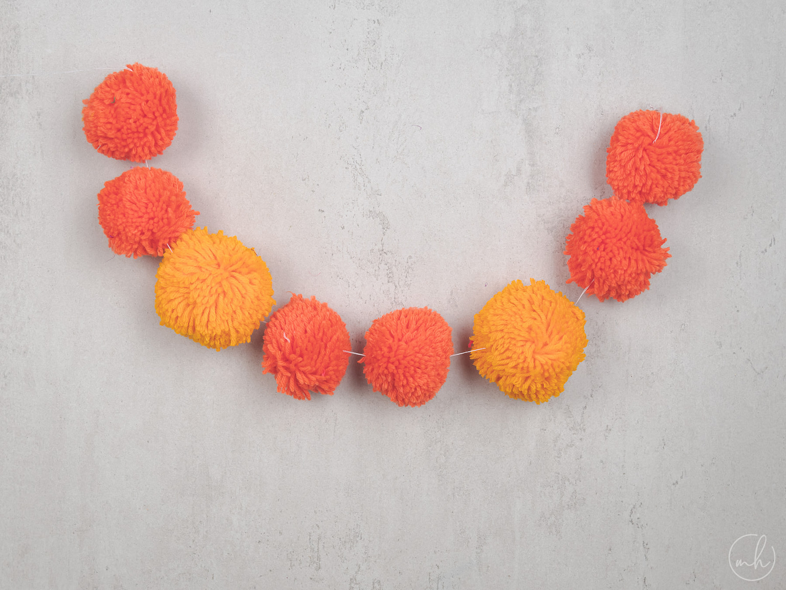 Red-yellow pompoms strung on a thread