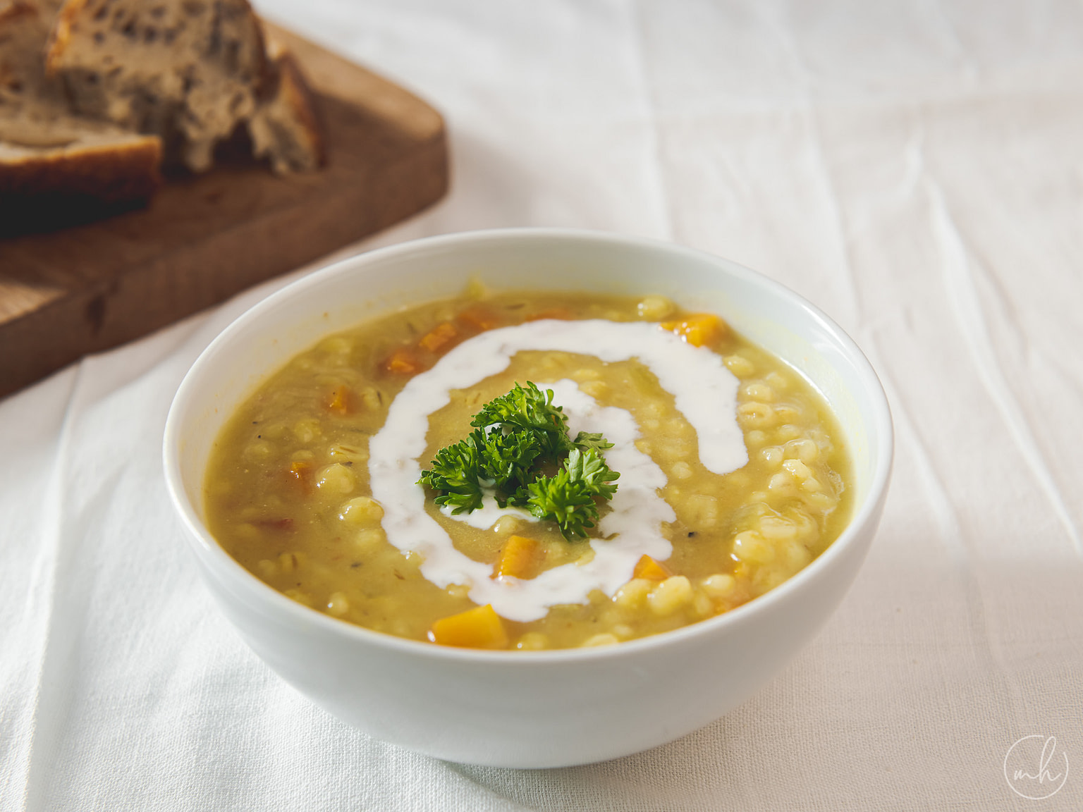 creamy bowl persian pearl barley soup served with sourdough